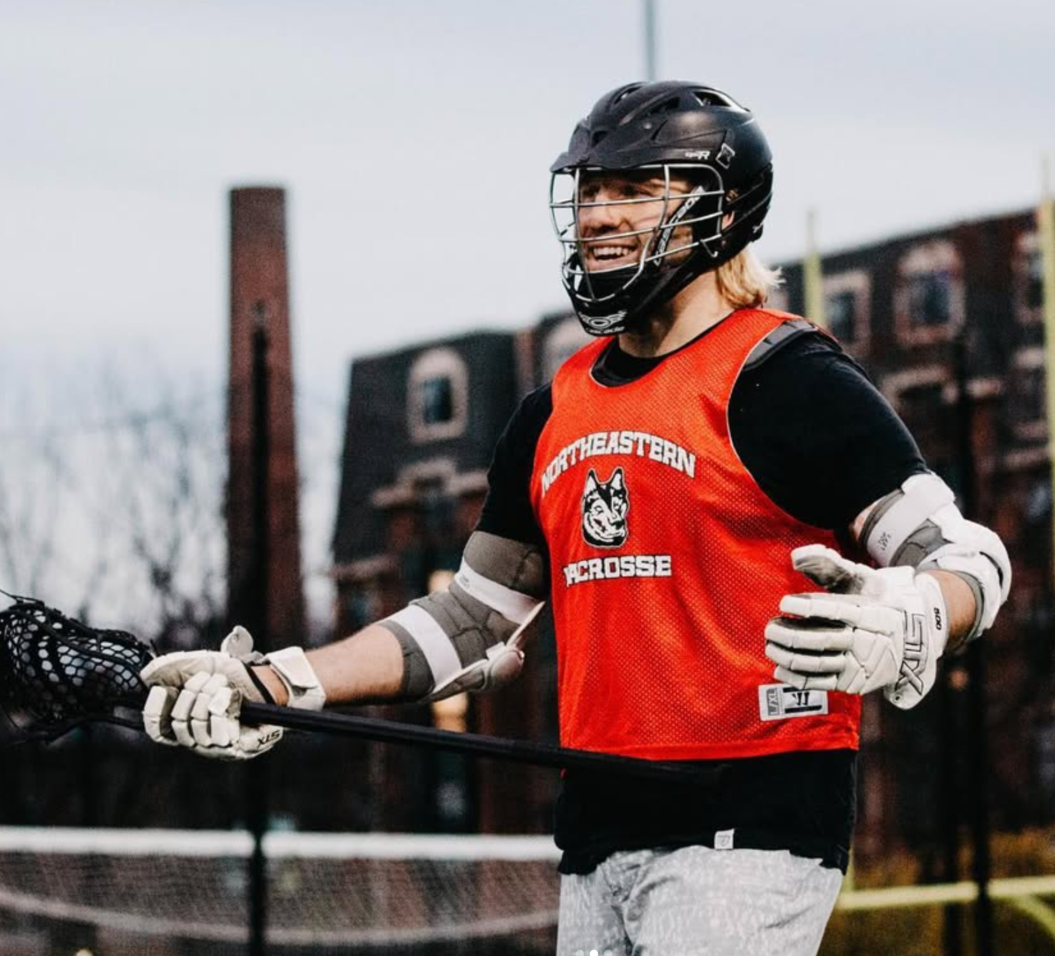 Brett Fink playing lacrosse at Northeastern