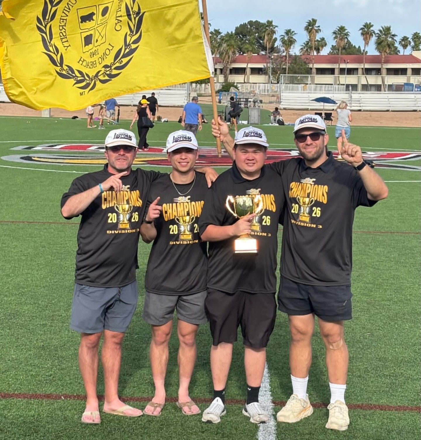 Brett Fink with the CSULB coaching staff celebrating the 2026 SLC championship
